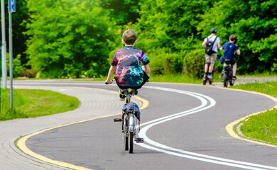 Fototapeta premium Cyclist ride on the bike path in the city Park