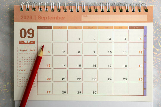 Desk calendar for September 2026 on a gray background.
