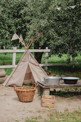 Children's teepee play tent in a rustic backyard garden © eugenivy