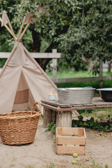 Children's teepee play tent in a rustic backyard garden © eugenivy