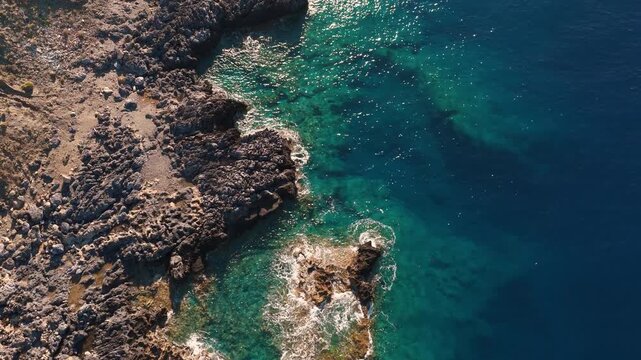 Aerial view on the Crete island rocky coastline with clear blue water on a sunny day of summer
