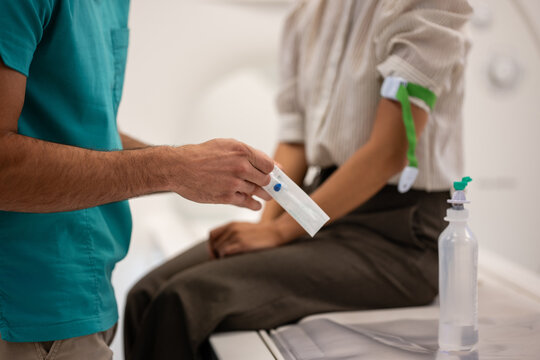 Medical professional preparing patient for intravenous injection