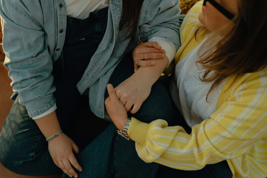 Two women share a tender moment holding hands