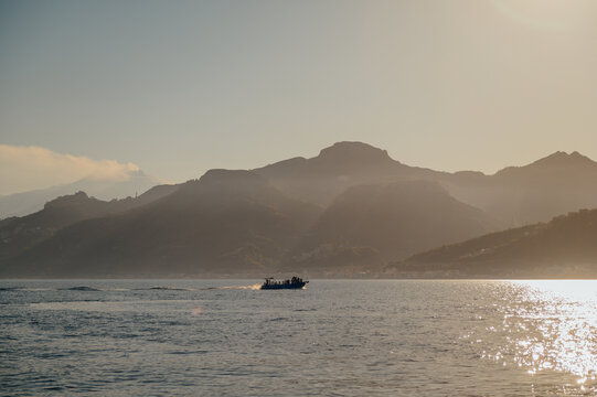 Dolphin watching boat at sunset on the Ionian Sea near Taormina