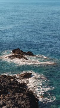 Crete island rocky coastline and the Mediterranean blue water, drone vertical video
