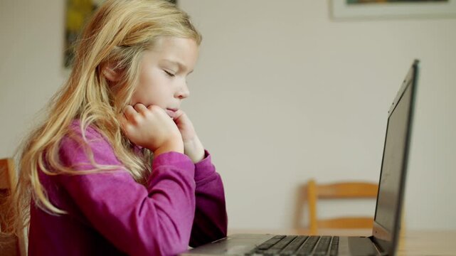 blond young girl running is working on laptop