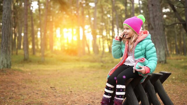 Beautiful smiling little girl with mobile phone