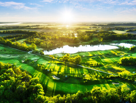 Aerial view drone shot of beautiful green golf field. Banner panorama background