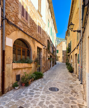 Narrow village street with flowers in Valldemossa in Mallorca, Spain