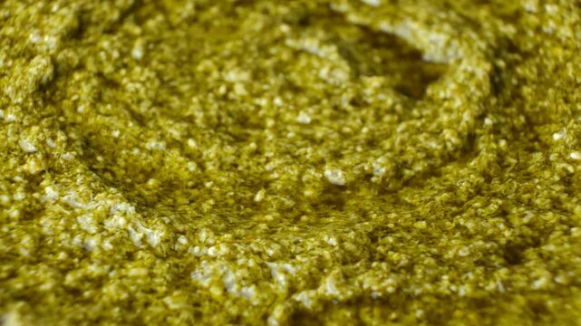 Traditional Italian basil pesto background slow rotating