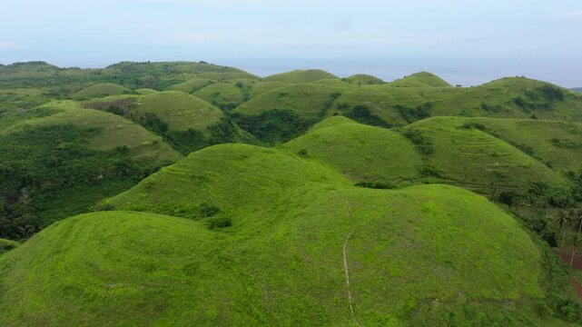 Drone Flight Over Teletubbies Hills with Endless Green Landscapes &ndash; Nusa Penida Indonesia Nature Scenery