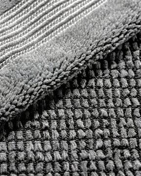 charcoal grey chenille bath mat texture with ribbed fabric border background