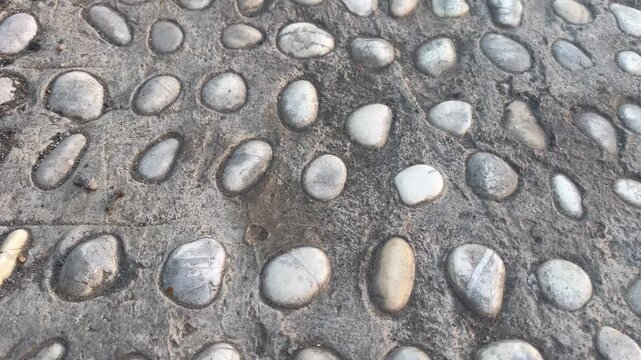 Detailed texture of textured cobble stone pavement outdoors