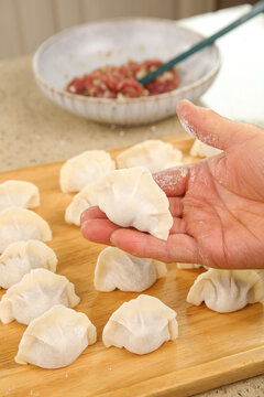 Fresh Handmade Chinese Dumplings with Pork and Mushroom Filling for Traditional Holiday Cooking
