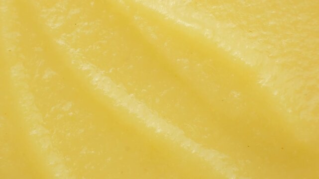 Macro texture of smooth organic apple puree top view.