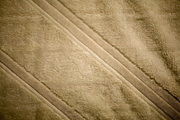 Taupe brown ribbed plush fabric textured surface background © Design Infinity