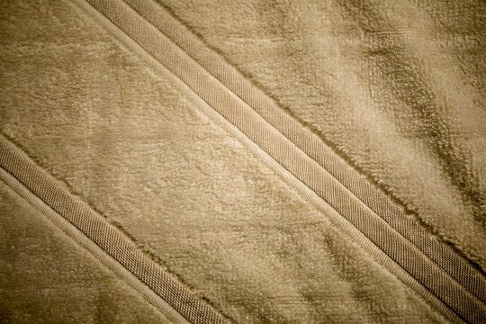 Taupe brown ribbed plush fabric textured surface background