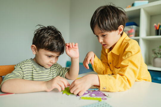 Child studying and learning mechanics with a toy indoors