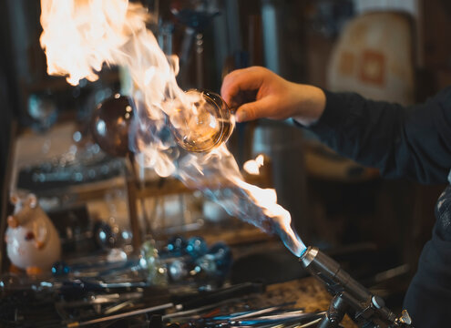 Glass blower forming melting glass