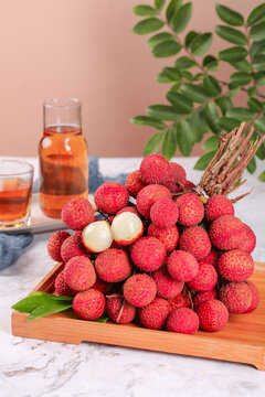 Fresh Hainan Lychees on Wooden Board with Tropical Beverage