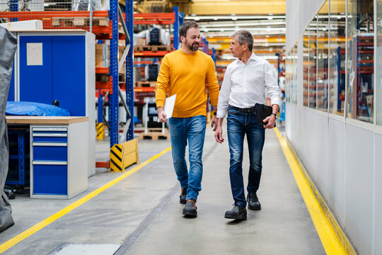 Businessmen walking together in factory