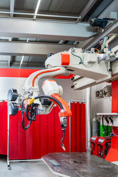 Automated industrial welding robotic arm in a modern factory