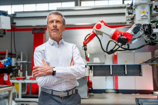 Confident manager standing in modern automated factory