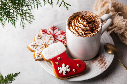 Christmas cookies and mug of frothy hot chocolate