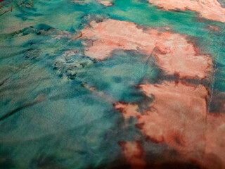 Naklejka premium sheer organdy fabric with an abstract pattern in turquoise and reddish-orange