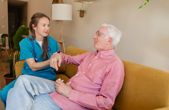 Nurse helping patient with rehabilitation at home