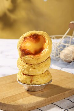 Portuguese Egg Tarts Past&eacute;is de Nata Golden Custard Pastry Stack on Wooden Board