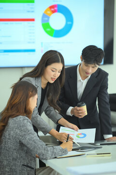 Business team reviewing strategy on laptop during meeting