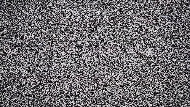 Classic television test pattern transitions to static and digital noise