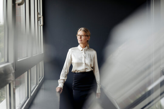 Businesswoman in office looking out of window