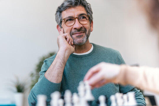 Thinking about strategy during a chess match indoors