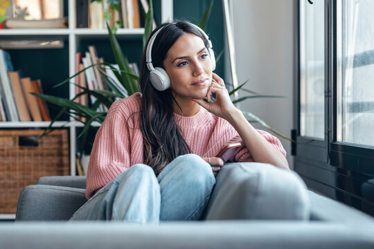 Listening to music and relaxing on a cozy sofa indoors