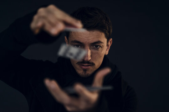 Portrait of magician conjuring with playing cards