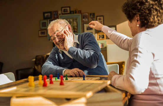 Senior couple playing ludo