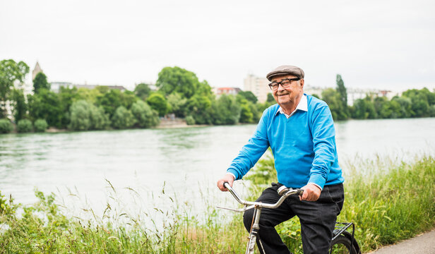 Smiling senior man riding bicycle