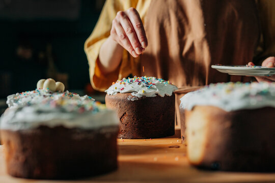 Hand decorating traditional Easter paska bread in the kitchen