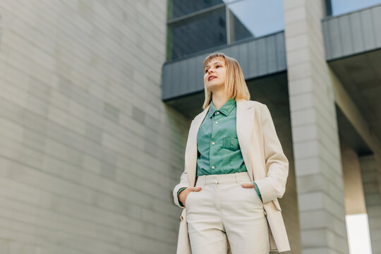 Confident businesswoman walking outside modern office building