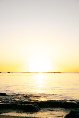 Obraz premium Calm tropical ocean reflecting golden sunset