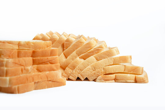 Fresh sliced white bread neatly arranged in a row on a clean white background, isolated for bakery, food, and breakfast concepts.