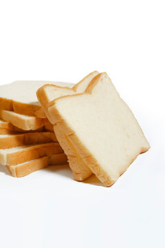 Vertical stack of fresh sliced white bread isolated on a white background, soft sandwich loaf bakery product.