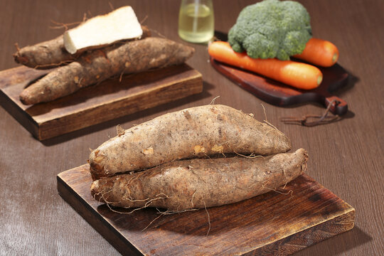 Fresh Yam Tubers with Vegetables on Wooden Cutting Boards - Healthy Organic Ingredients