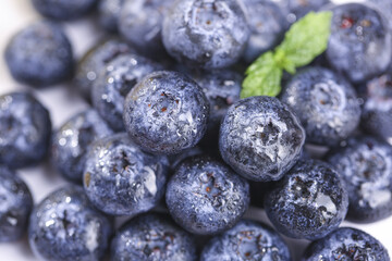Fresh Blueberries with Water Droplets and Mint Leaf - Healthy Superfood Berry Close-up © NgoThi