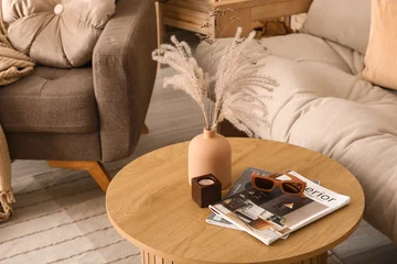 Fototapeten Musik Vase with dry reeds, sunglasses and magazines on table in living room  © Pixel-Shot