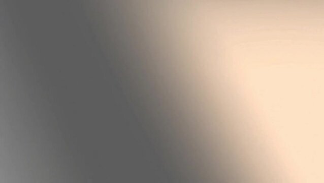 Smooth abstract gradient background transitioning from dark grey to light beige.