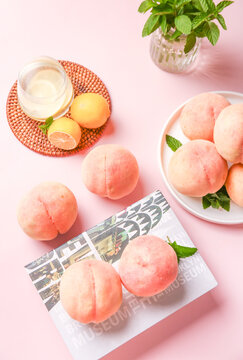 Fresh Yangshan Peaches and Lemons with Cream on Pink Background