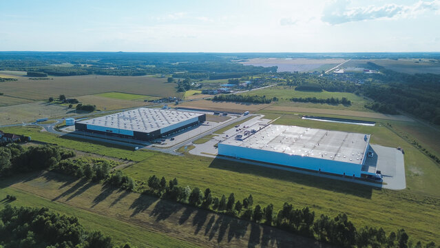 Two industrial warehouses in countryside